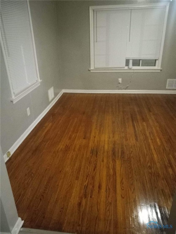 empty room featuring dark wood-type flooring