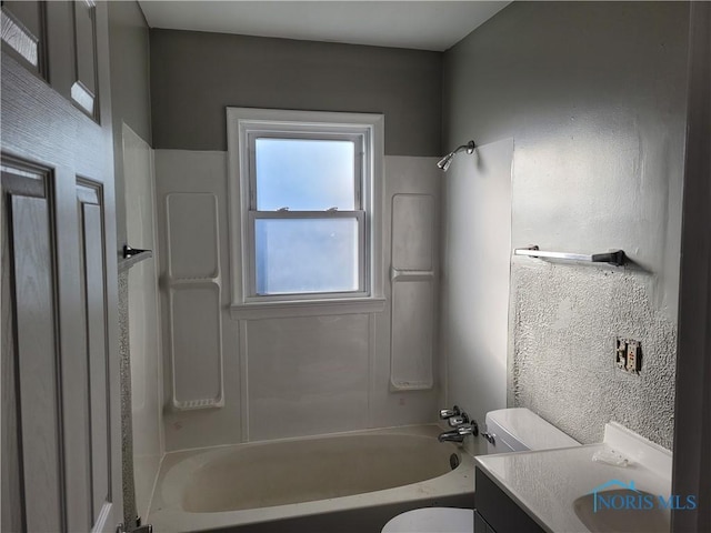 full bathroom featuring vanity, bathtub / shower combination, and toilet