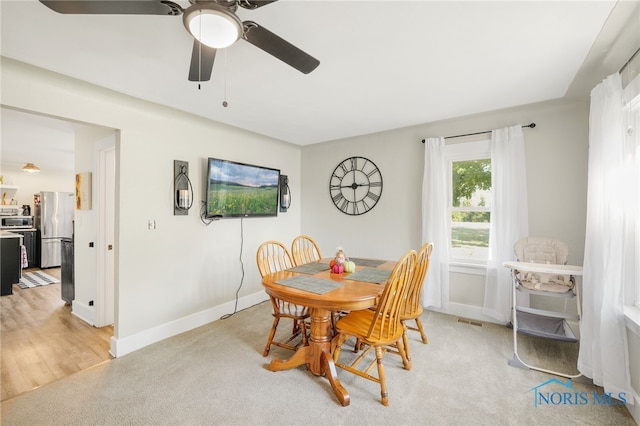 carpeted dining area featuring ceiling fan