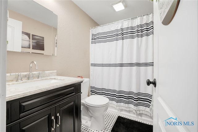 bathroom featuring vanity, toilet, and a shower with shower curtain