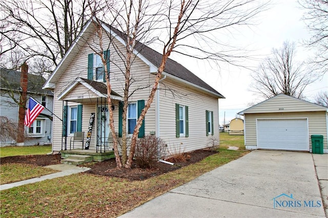 view of front of property featuring a garage and an outdoor structure