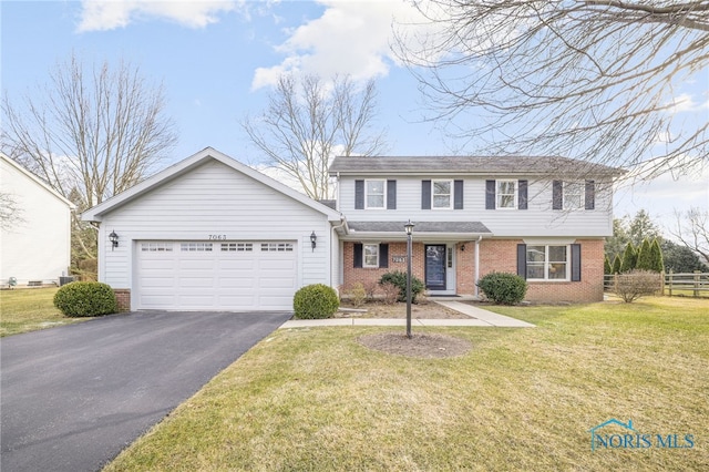 view of front of property with a garage and a front lawn