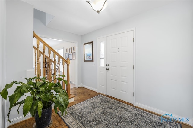 foyer featuring parquet flooring