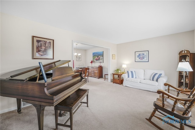 carpeted living room with a notable chandelier