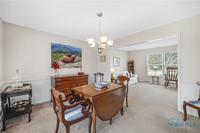 carpeted dining room featuring a notable chandelier