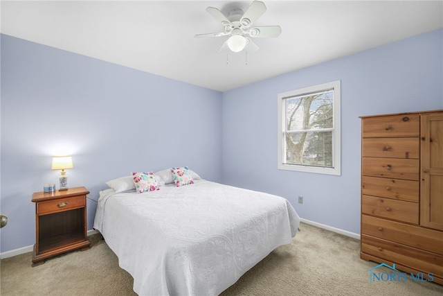 bedroom with ceiling fan and light carpet