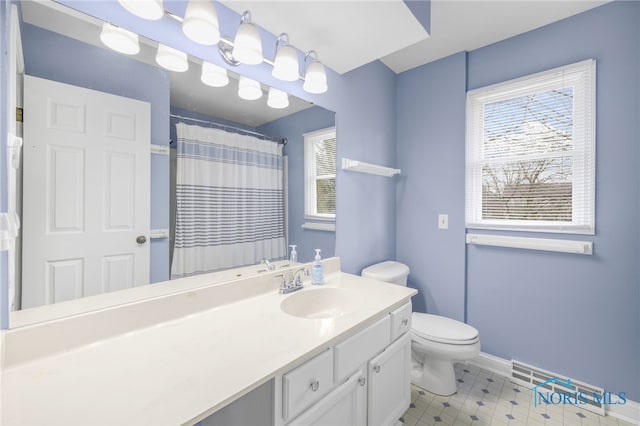 bathroom featuring vanity, a shower with shower curtain, and toilet