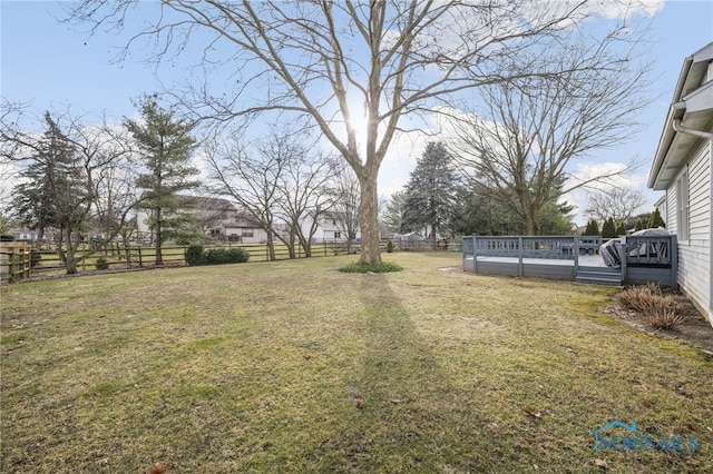 view of yard with a pool side deck