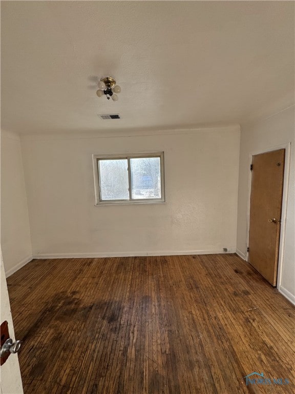 spare room with dark wood-type flooring