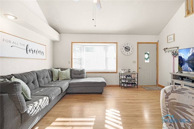 living room featuring ceiling fan, lofted ceiling, and light wood-type flooring