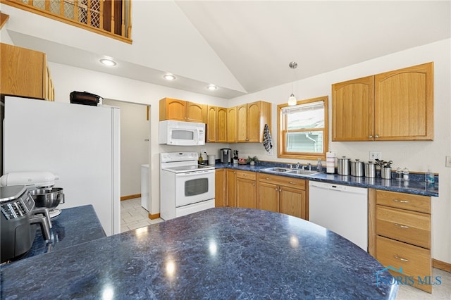 kitchen with high vaulted ceiling, sink, white appliances, and decorative light fixtures