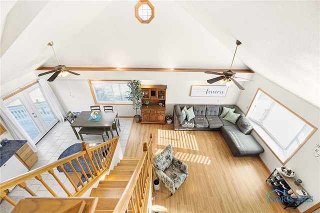 living room featuring high vaulted ceiling and light wood-type flooring