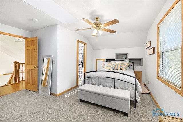 carpeted bedroom with vaulted ceiling and ceiling fan