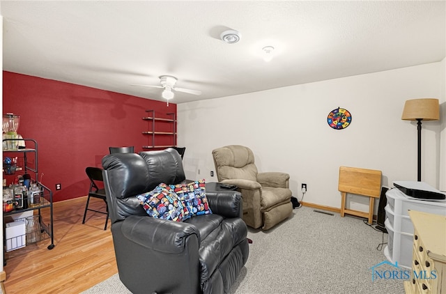 living room with hardwood / wood-style flooring and ceiling fan