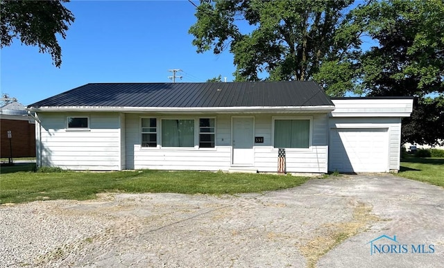 ranch-style house with a garage and a front yard