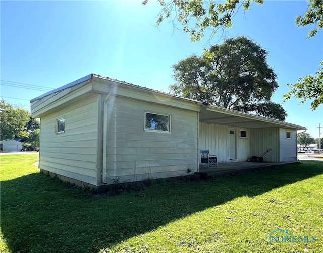 view of side of home featuring a lawn