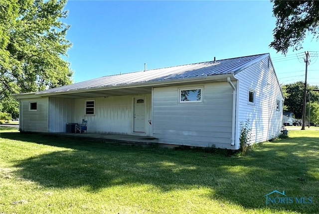 back of house with a yard and central air condition unit