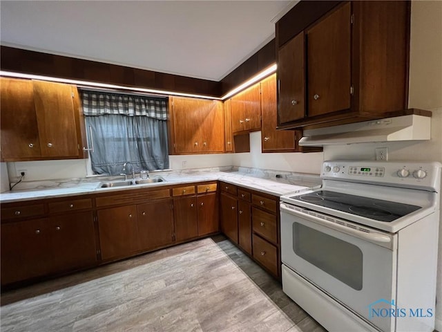 kitchen with sink, white electric range, and light hardwood / wood-style floors