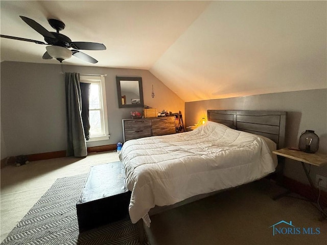 carpeted bedroom featuring vaulted ceiling and ceiling fan