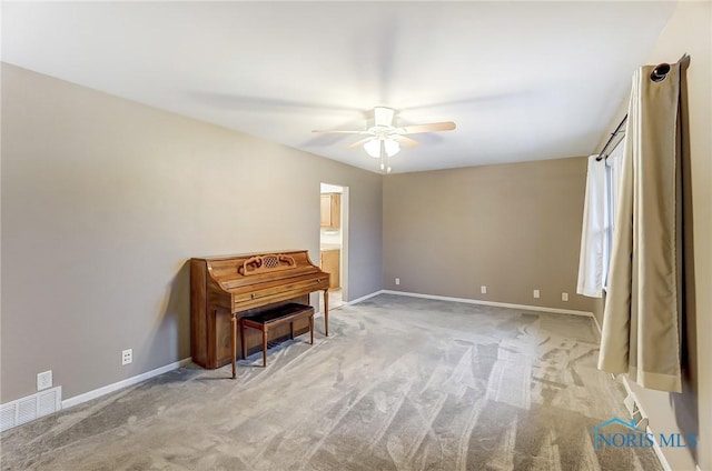 misc room with ceiling fan and light carpet