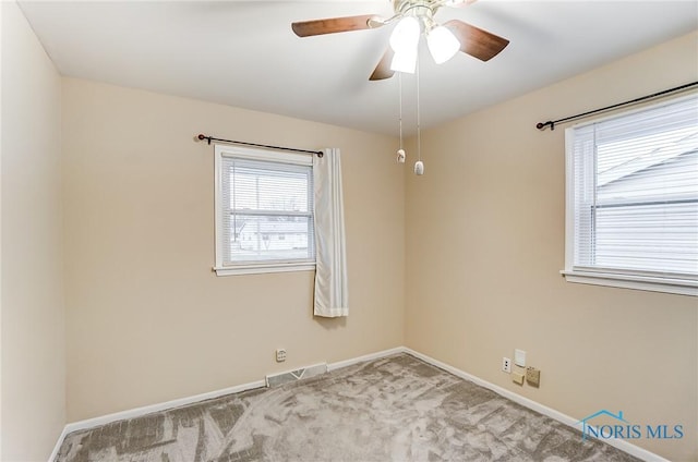 carpeted spare room with ceiling fan