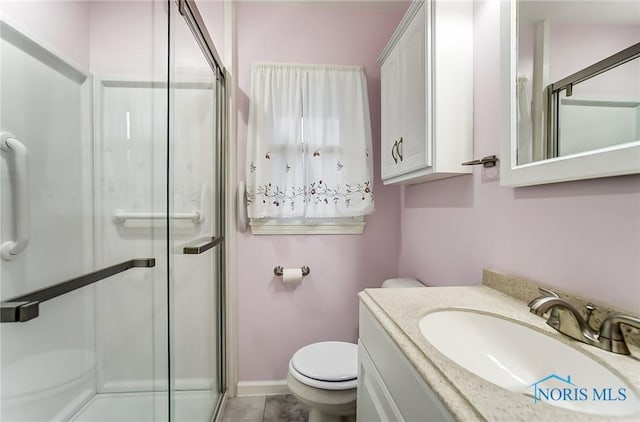 bathroom featuring walk in shower, vanity, and toilet