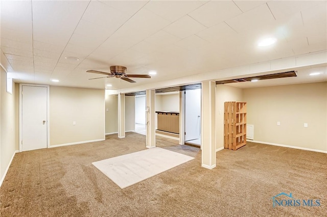 basement featuring carpet flooring and ceiling fan