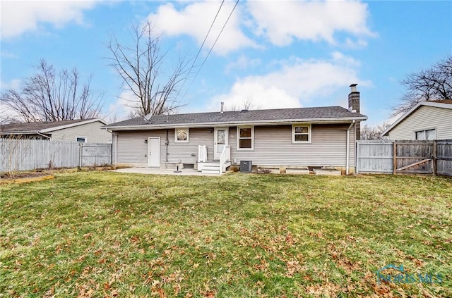 back of house with central AC, a yard, and a patio area