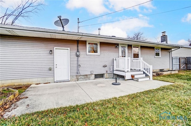 rear view of house with a yard and a patio area