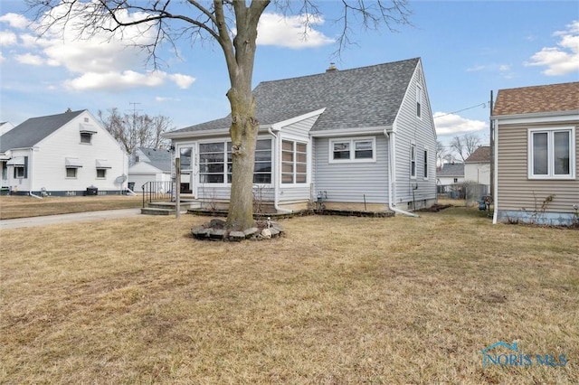 rear view of property with a yard