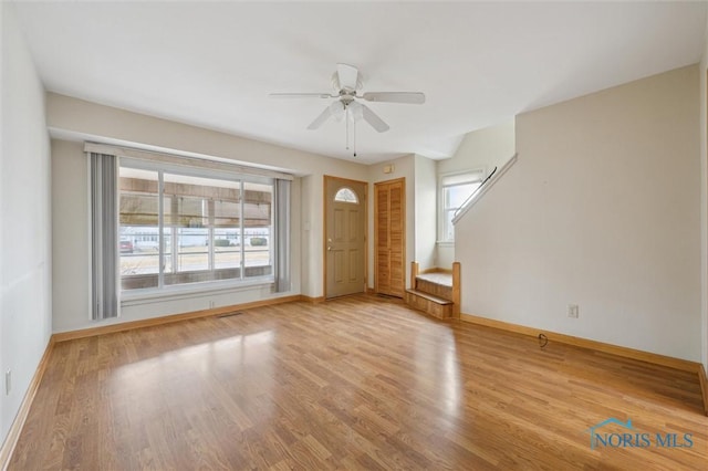 unfurnished living room with ceiling fan, light hardwood / wood-style flooring, and a wealth of natural light