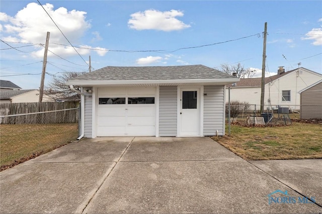 garage featuring central AC unit and a yard