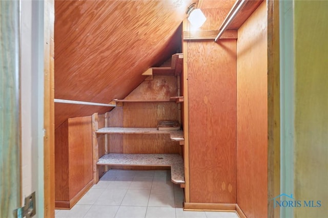 stairs featuring tile patterned flooring and lofted ceiling