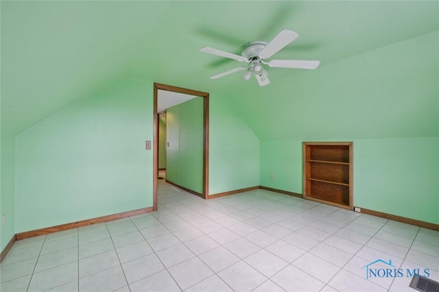 bonus room featuring lofted ceiling, light tile patterned floors, built in features, and ceiling fan