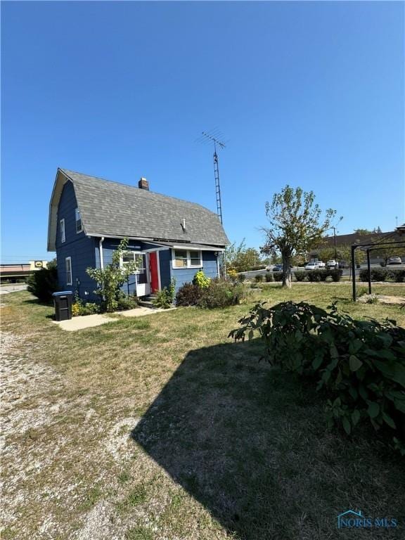 exterior space featuring central AC and a yard