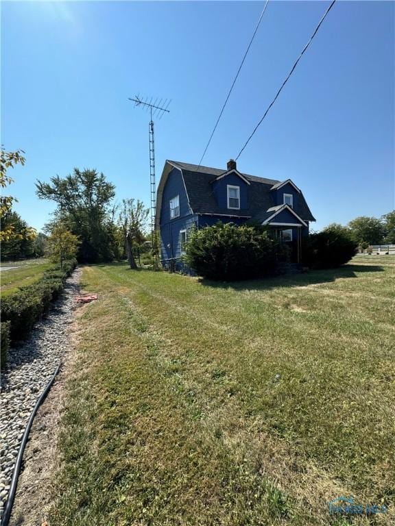 view of side of property with a yard