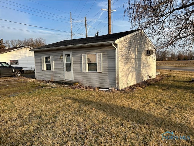 back of house with a lawn