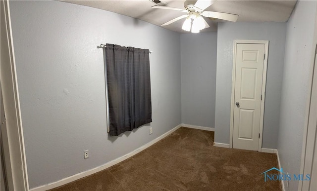 unfurnished room featuring carpet floors, ceiling fan, and baseboards