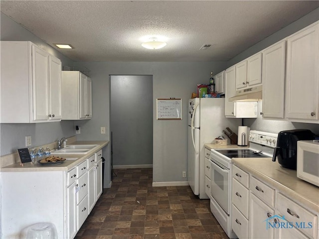 kitchen with white appliances, visible vents, light countertops, under cabinet range hood, and a sink