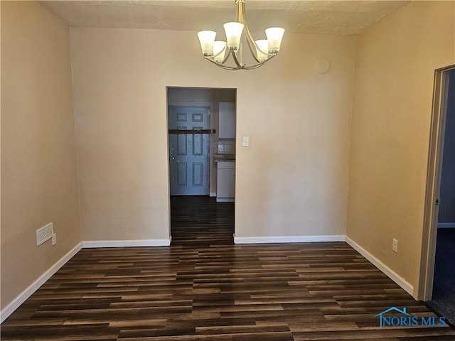 unfurnished dining area with a notable chandelier and dark hardwood / wood-style floors