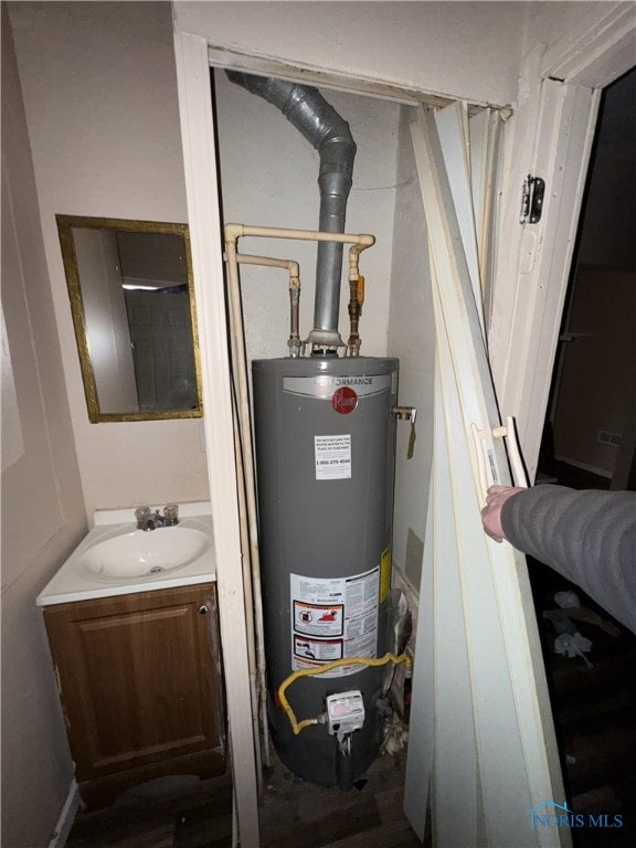 utility room with sink and water heater