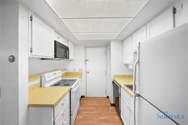 kitchen featuring light wood-style floors, light countertops, white appliances, and white cabinetry