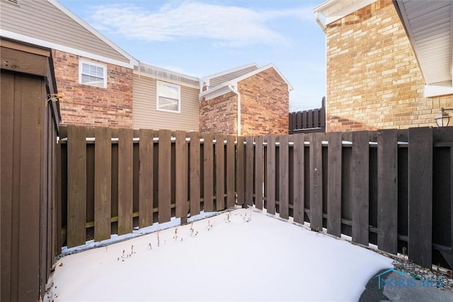 snow covered patio with fence