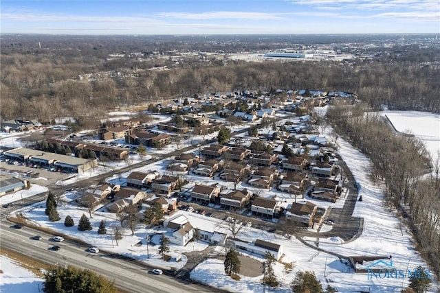 snowy aerial view featuring a residential view