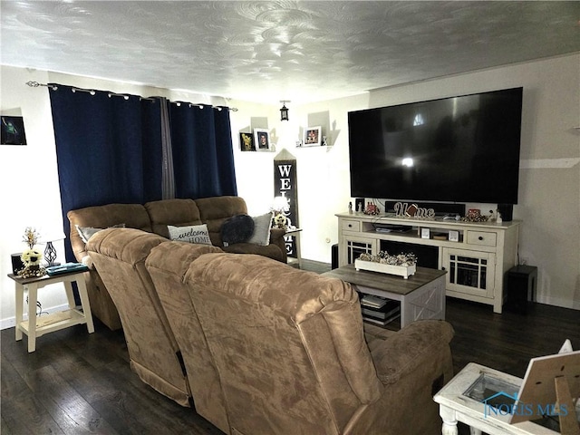 living room with dark wood-type flooring and a textured ceiling