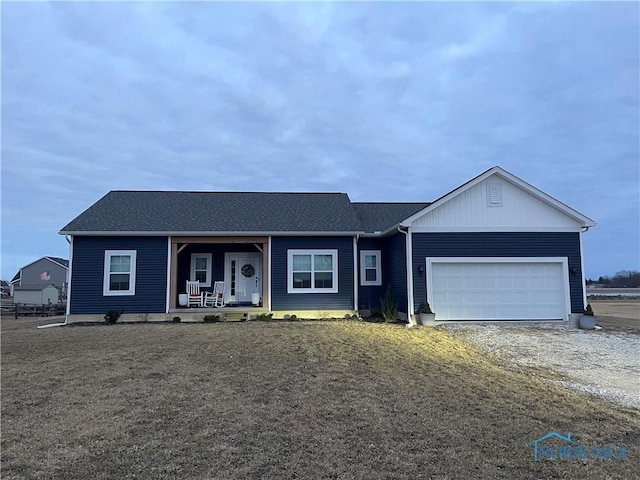 single story home featuring a garage and covered porch