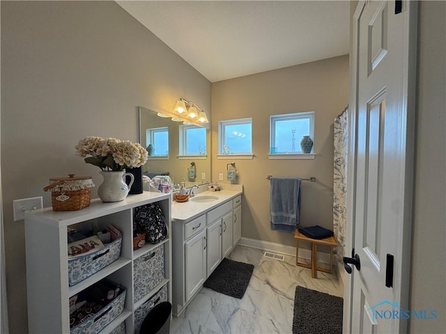 bathroom featuring vanity and curtained shower