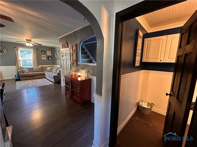 hallway featuring ornamental molding and dark wood-type flooring