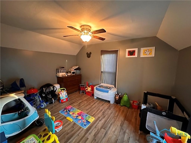 playroom with hardwood / wood-style flooring, ceiling fan, and vaulted ceiling