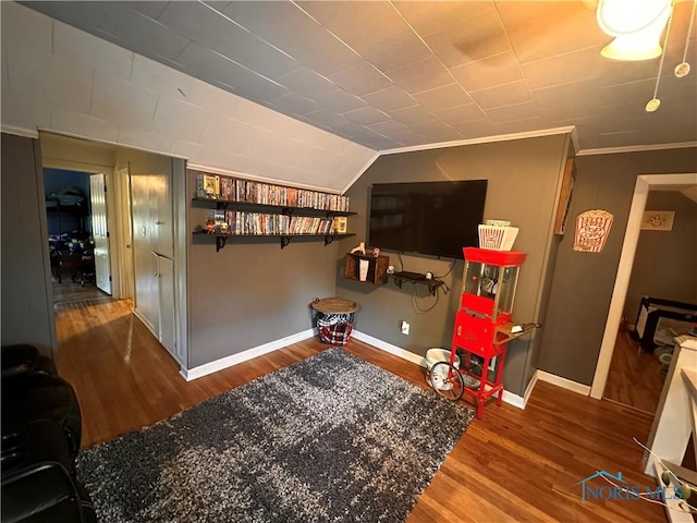 playroom with hardwood / wood-style flooring, ornamental molding, and vaulted ceiling